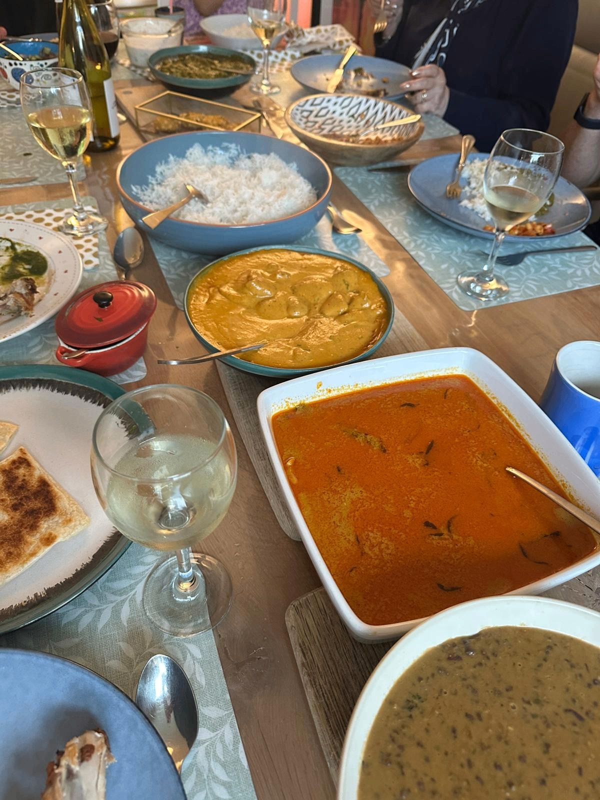 A long table laid with curries, rice and naan at a Curry Studio private dinner
