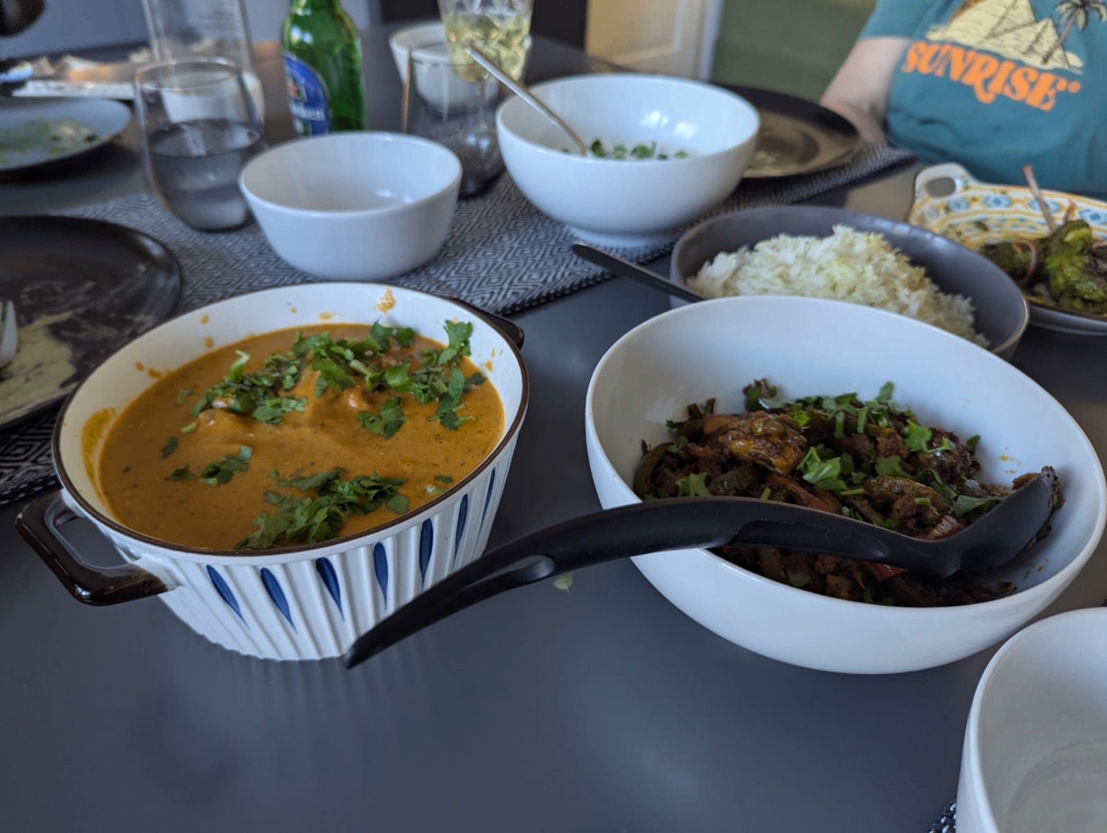 Bowls of dal and a slow-cooked meat dish served at a gathering catered by The Curry Studio
